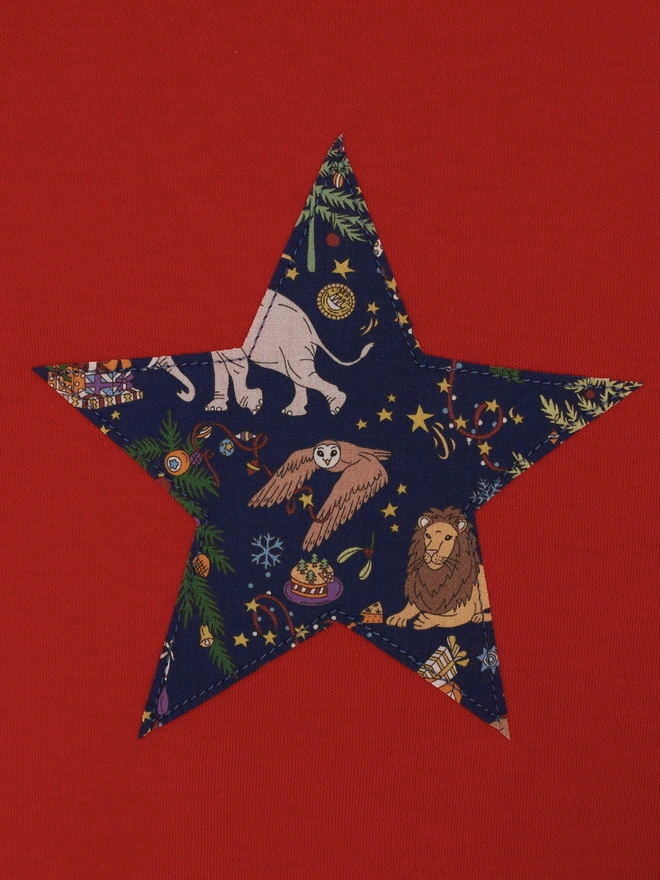 a red t-shirt with a Christmas liberty print star appliquéd on the front