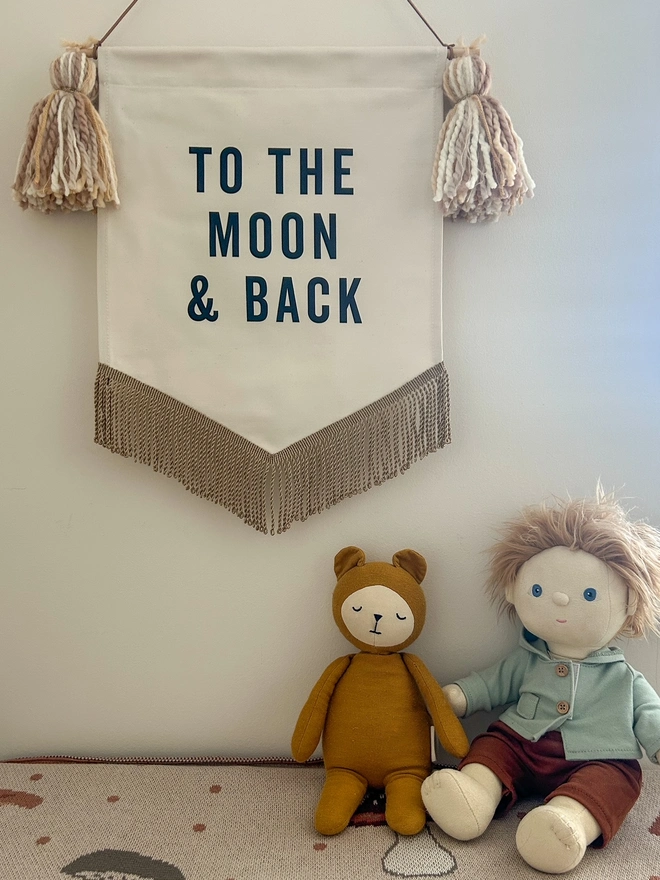 to the moon and back handmade fabric banner with tassels and gold trim