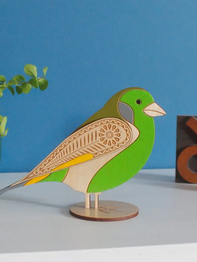 Standing Wooden Greenfinch, green wooden bird standing on a platform. 