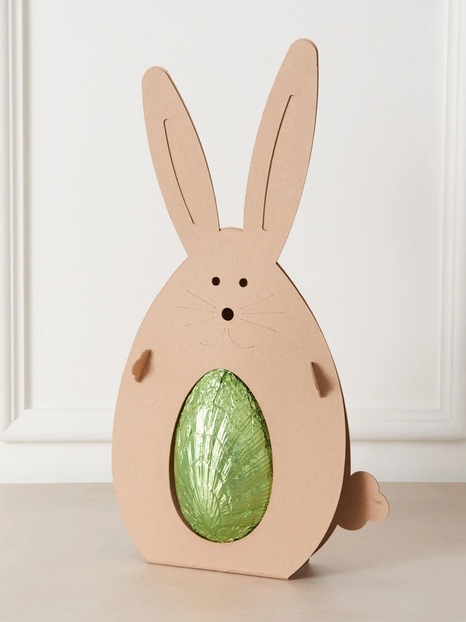 ginger dark chocolate easter egg 72%. a dark chocolate easter egg photographed in green foil in a cardboard rabbit.