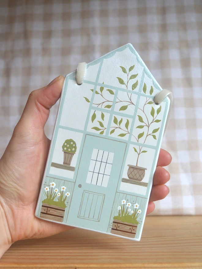 white hanging decoration with white and blue greenhouse design