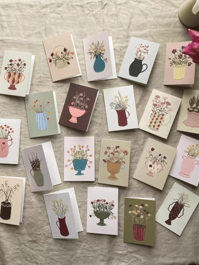 collection of mini floral cards with flowers on in vases.