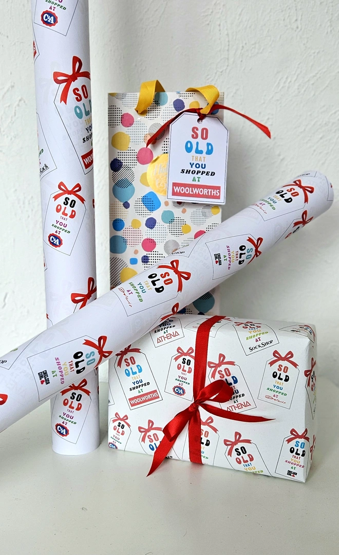 A photograph of wrapping paper and a present the design says so old that you shopped at Woolworths and other shops popular in the 1970's and 1980's