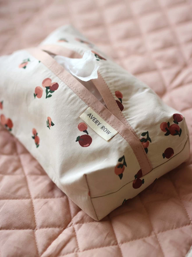A wipes cover made for babies in peaches print