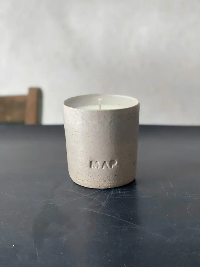 'St Helena' Soy Wax Candle And Ceramic Holder. ceramic candle pot photographed in pottery studio. 