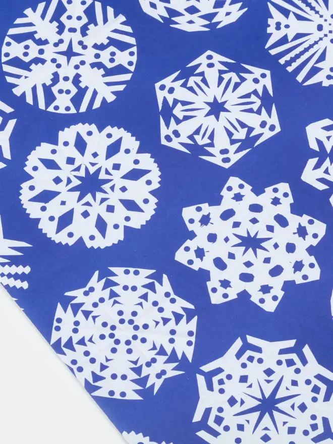 blue wrapping paper with white snowflaked