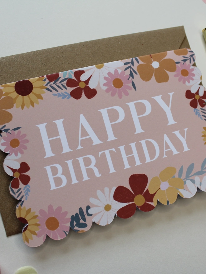 floral happy birthday card. scallop edged birthday card with illustrated flowers.
