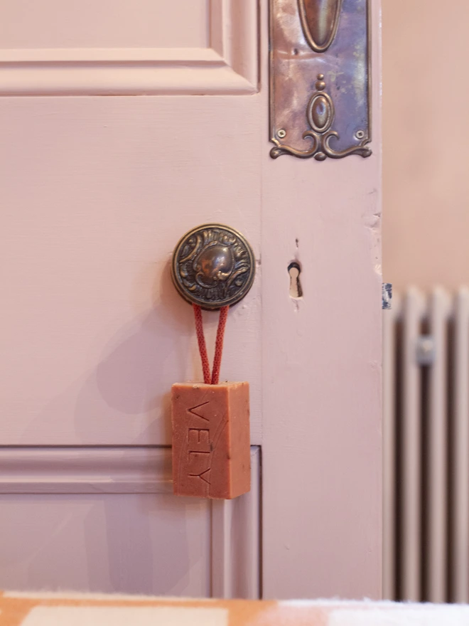 Soap on a rope Boudoir on a pink door handle
