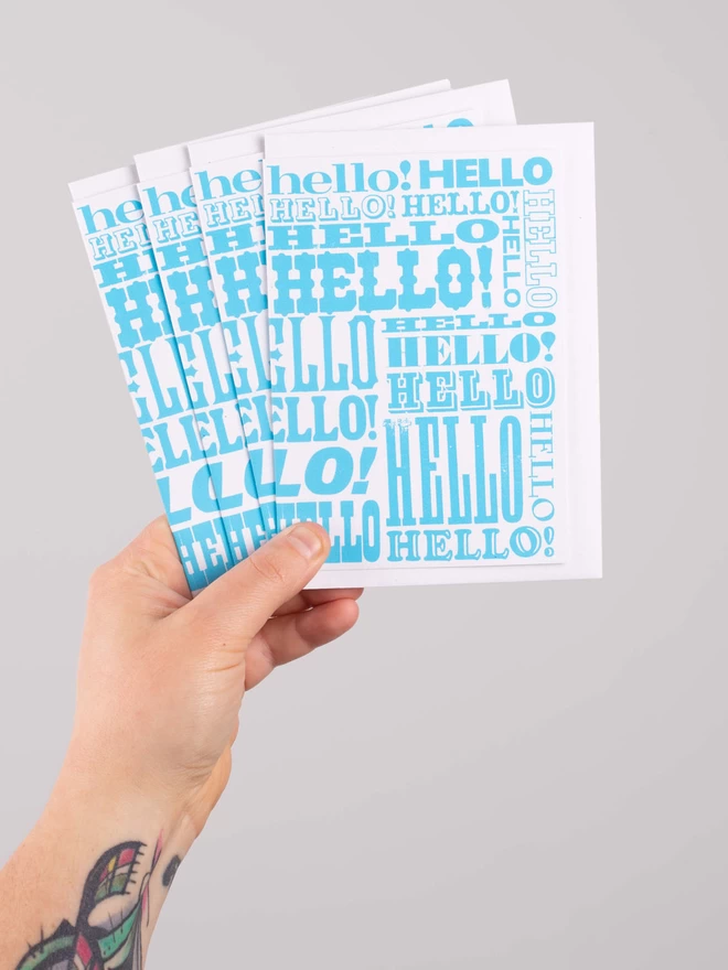 Blue Greetings Card with Hello written all over it in different fonts a pack of 4