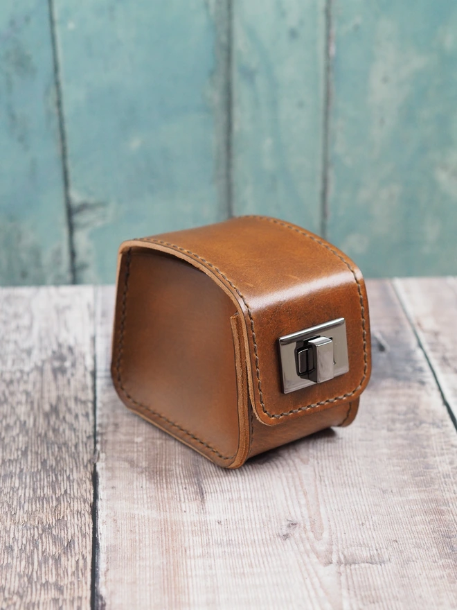 Hand dyed tan brown leather watch case with gunmetal grey metalwork.
