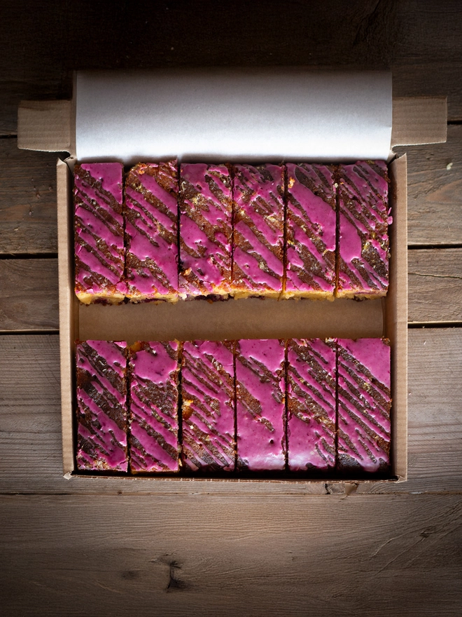 A tray of 12 slice of Lemon and Blueberry Cake