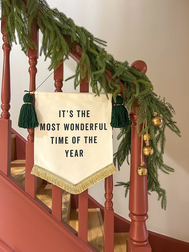 It's the most wonderful time of the year fabric christmas banner with dark green tassels and gold fringe trim