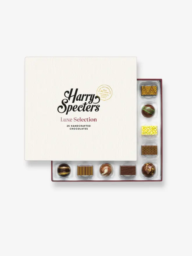 A box of 25 premium chocolates partially covered by a Harry Specters lid