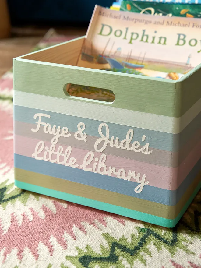personalised kids' book storage box. a personalised wooden book box full of books.