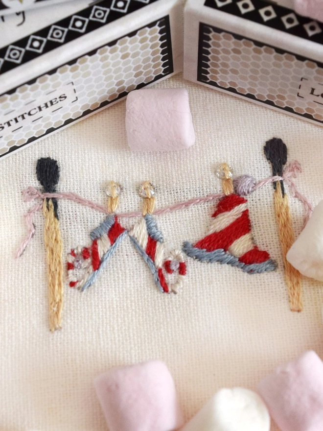 The elves have hung their hats and shoes up to dry on a washing line of matchsticks… having a well deserved duvet day.