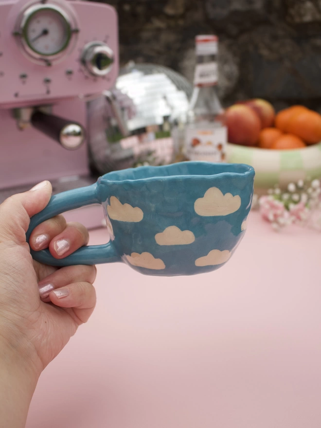 bright blue handmade stoneware pottery mug with white cloud pattern