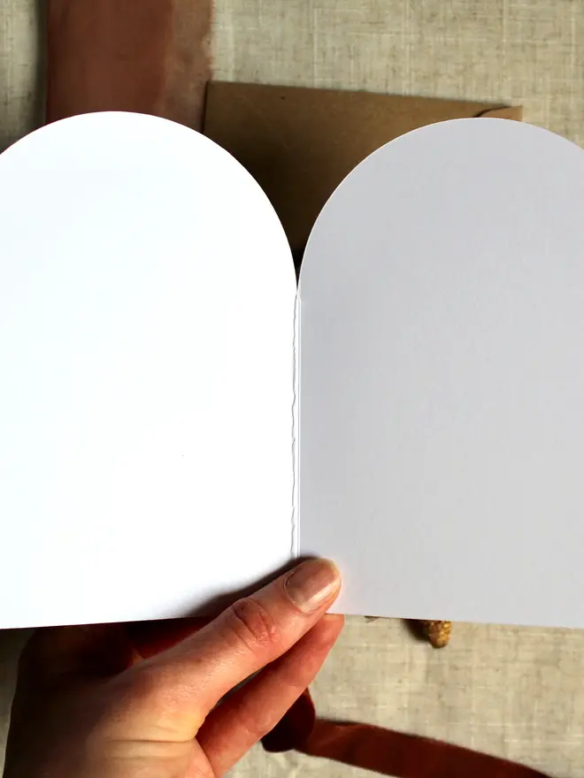 illustrated christmas wreath card. arch shaped christmas card open to show blank inside.