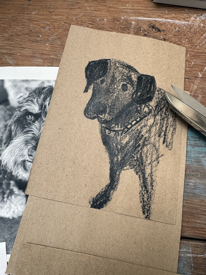 drawings of dogs on brown paper on a drawing board