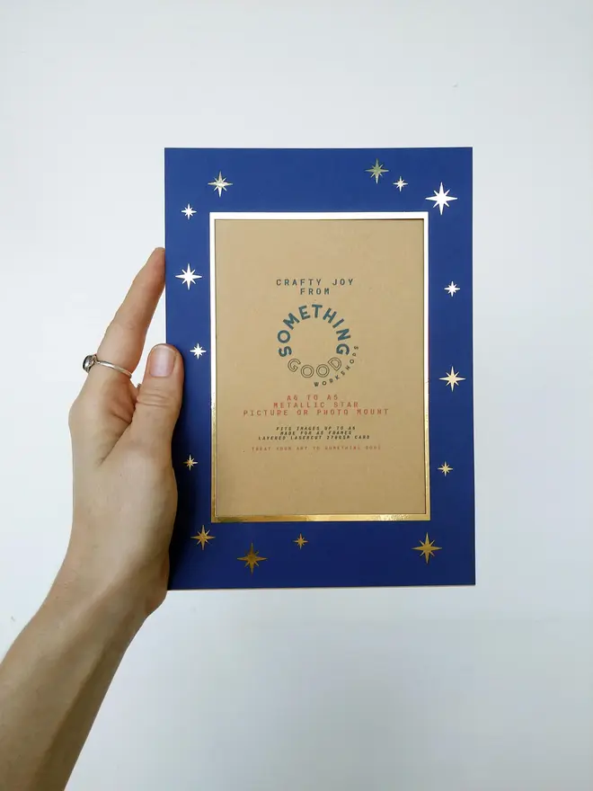 metallic star a5 / a4 christmas photo mount. blue mount photographed against grey background.