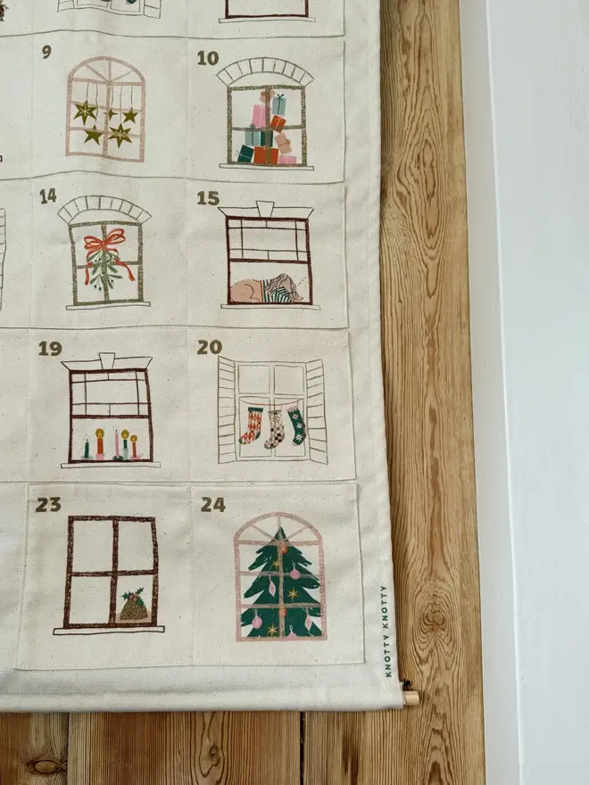 Fabric Christmas House Advent Calendar, hanging on a door. 
