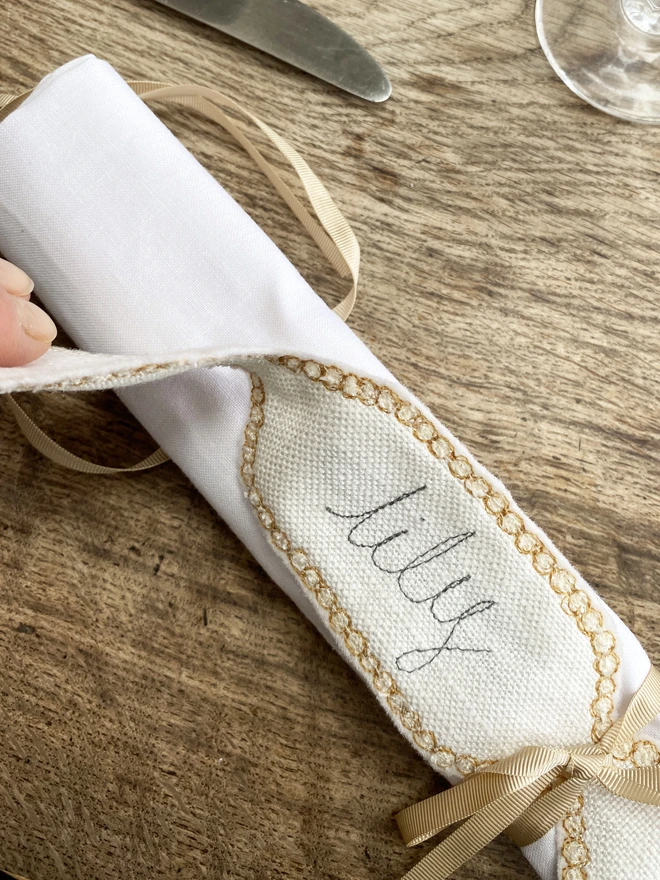 Fabric Cracker Napkin Decoration on table being removed from napkin