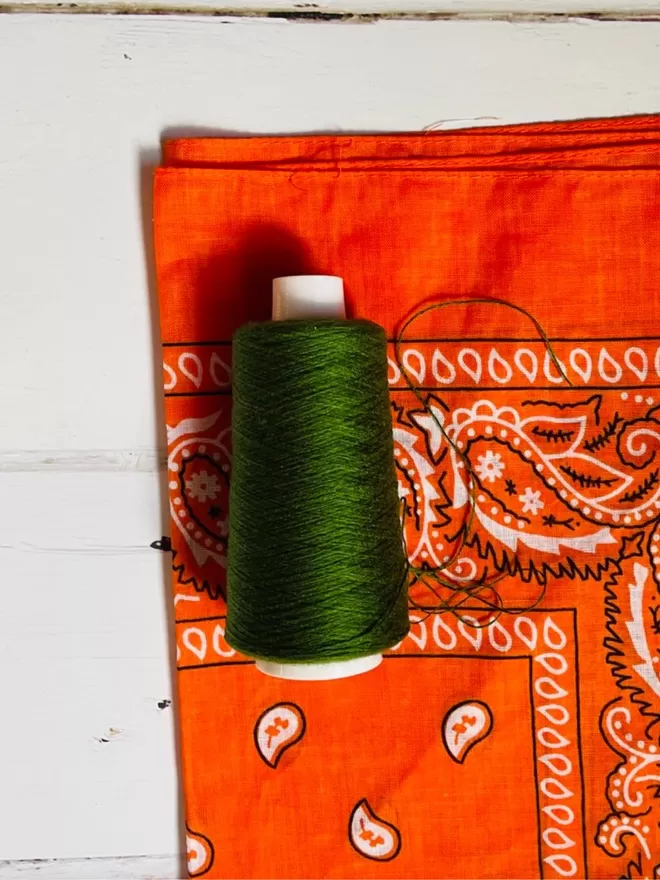 Orange bandana with green thread.