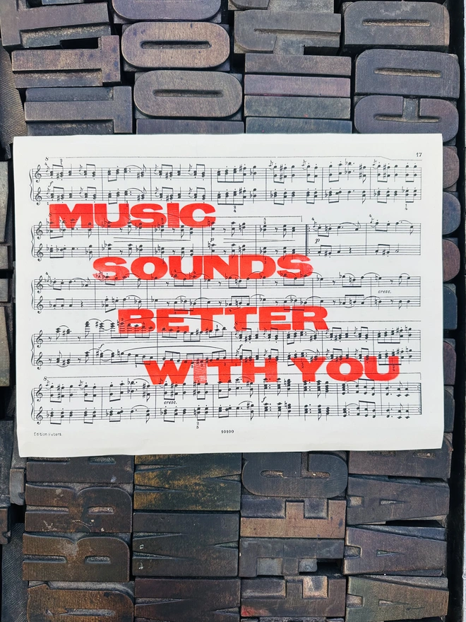 Music Sounds Better Letterpress print on sheet music. wooden type background