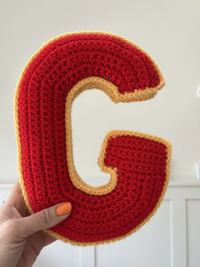Crochet G cushion in Red and Pale Orange