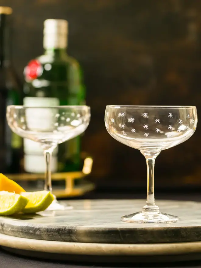 engraved stars crystal cocktail glass. two cocktail glasses patterned with small stars.