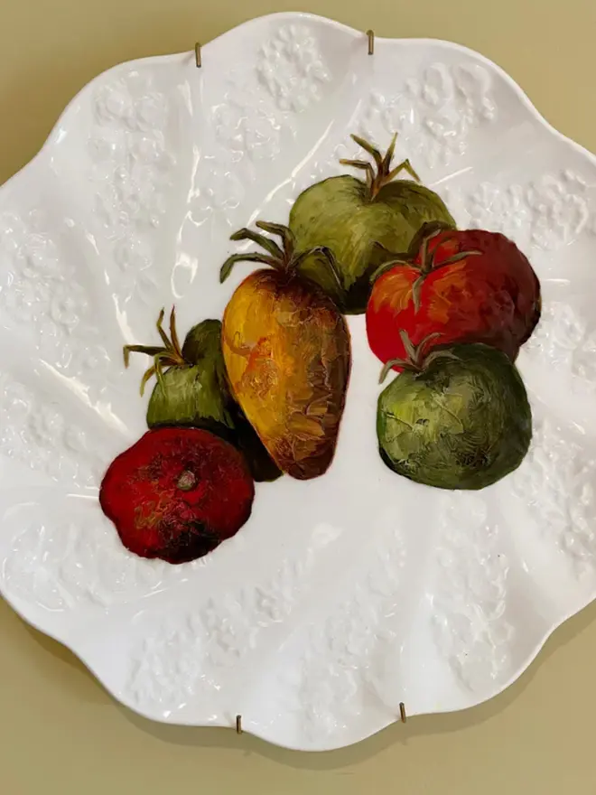 Oil Painted French Heritage Tomatoes On Antique Coalport against a beige background. 