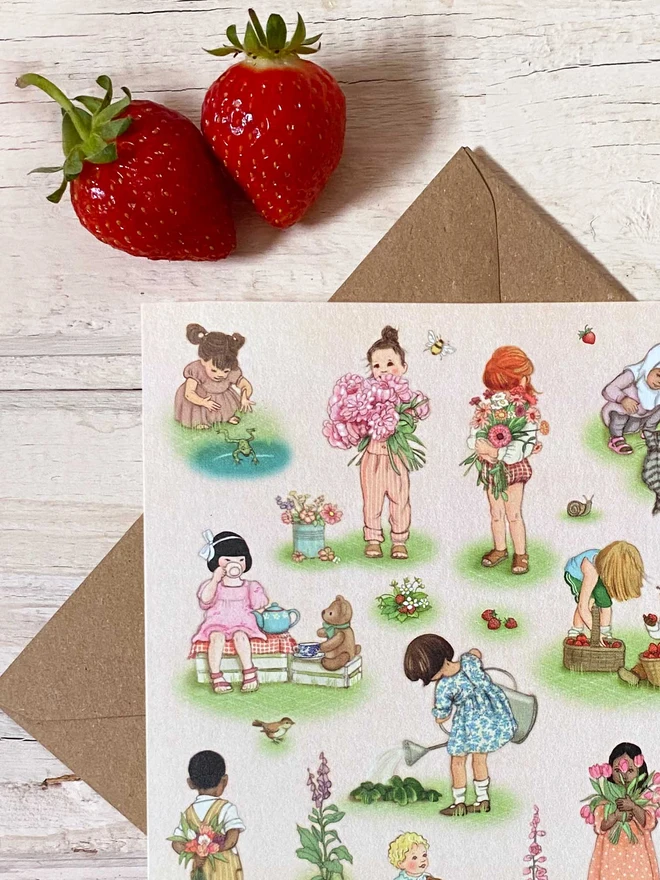 a pink greeting card drawings of children holding flowers picking strawberries