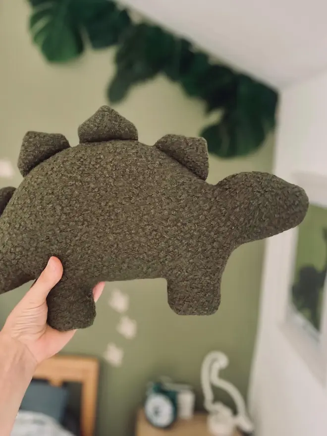 boucle dinosaur pillows. a green stegosaurus cushion.
