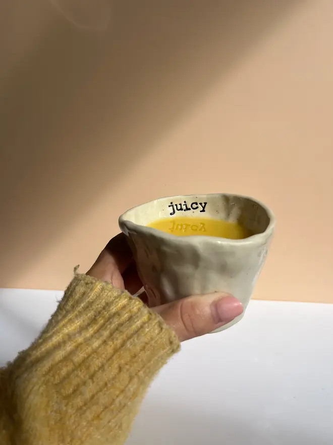 'Juicy' Kids Cup, held and filled with juice. 