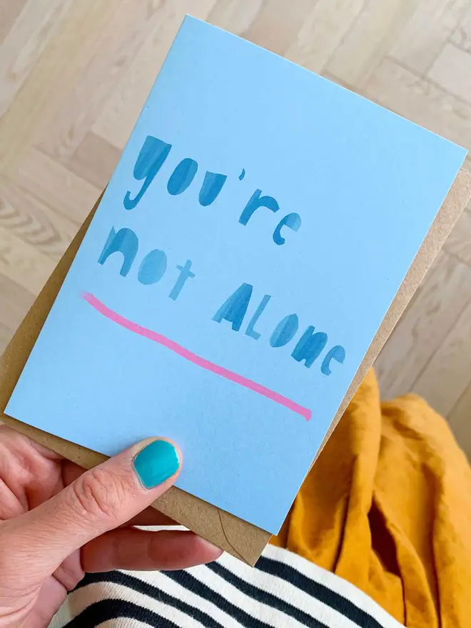 Card reads 'you're not alone'