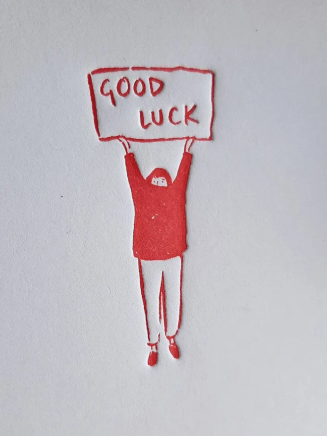 'Good Luck' Letterpress Handprinted Greetings Card, a white good luck card with an orange design. 