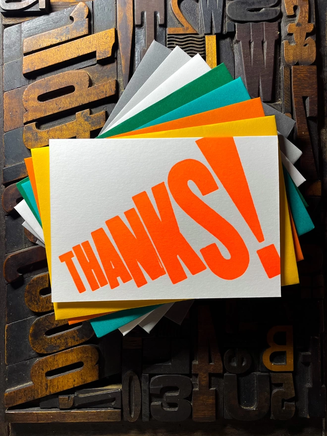 Thanks! A vibrant thank you typographic letterpress card with deep impression print using fluorescent orange, with a range of colourful envelopes. Slight print variations adding to the style anding to the charm of this handmade greeting card.