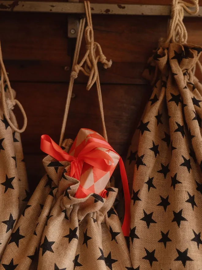 Christmas Star print sacks full of gifts