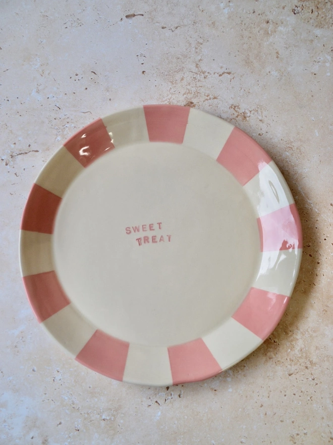 Handmade ceramic plate with pink and cream striped rim — “Sweet Treat” text in centre