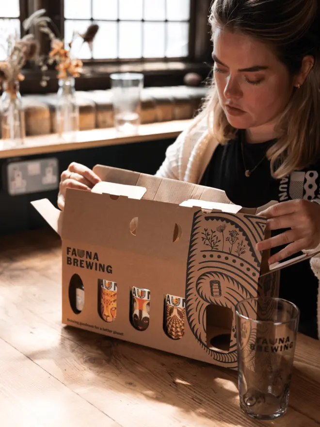 Fauna Brewing craft beer and elderflower gin gift box with illustrated pint glass opening 