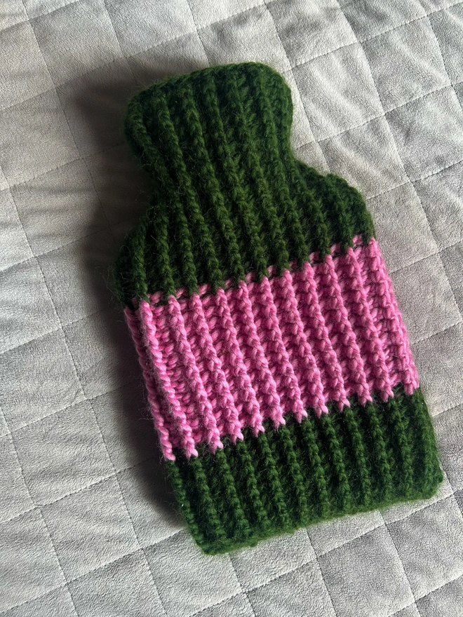 Ribbed pink crochet hot water bottle with a yellow stripe