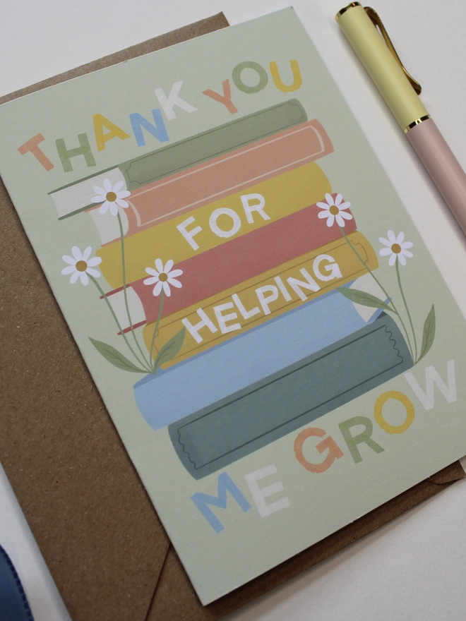 'thank you for helping me grow' illustrated card. green card with illustrated books and flowers.