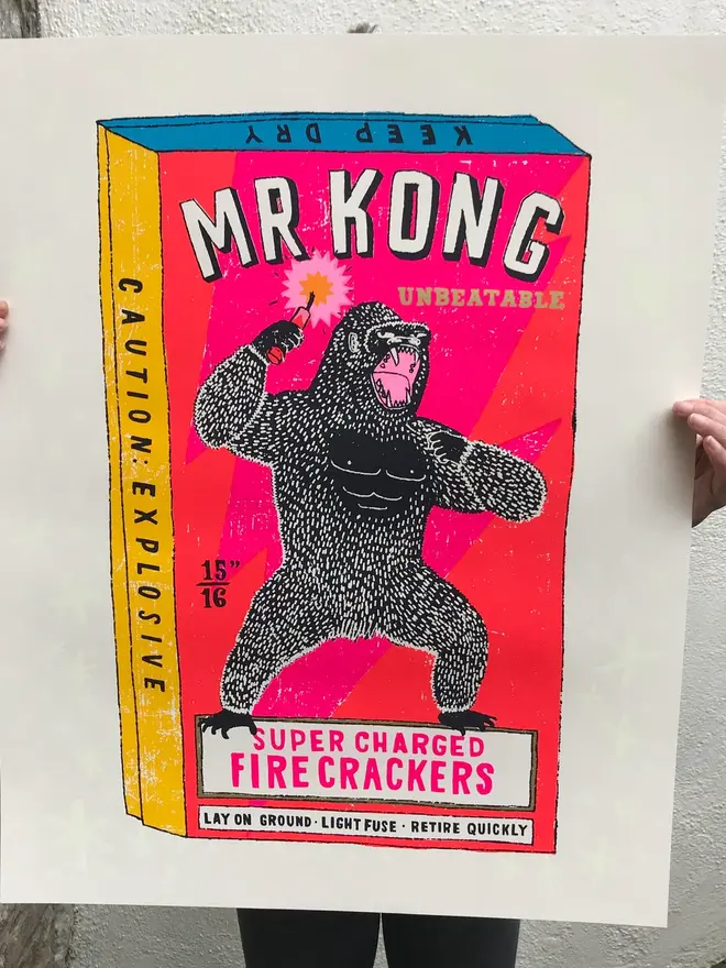 King Kong Screen Print The Magnificent Mr Kong, a colourful screen print held by a person in front of their body. 