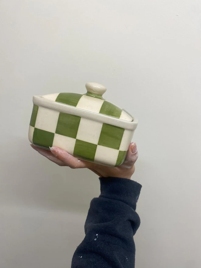  Checkered Green & Cream Handmade Ceramic Butter Dish, a green patterned butter dish held against a white backdrop. 