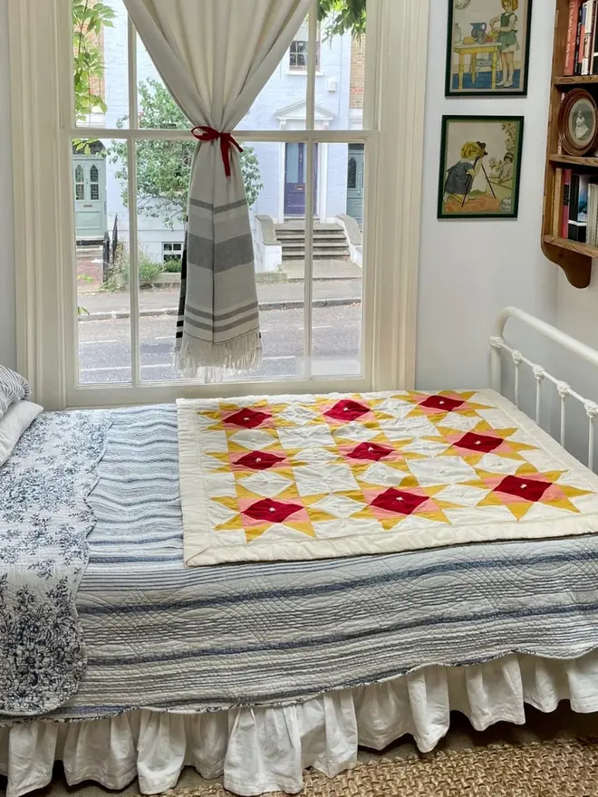 Warm Hearth Quilt Kit, on a bed. 