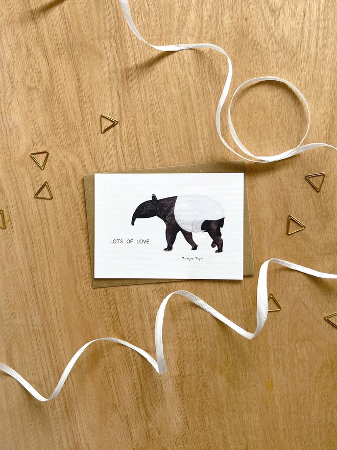  a greetings card featuring an illustration of a tapir with the text “lots of love”