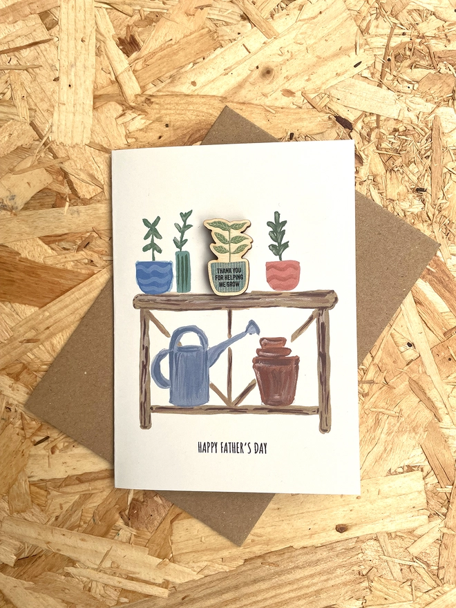 A6 Card with Potting bench illustration. Wooden Pin badge attached . With Brown envelope.