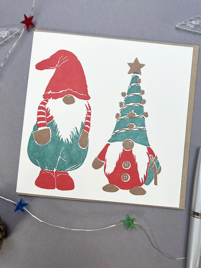 Front of the card with two red and green Gonks with one wearing a party hat