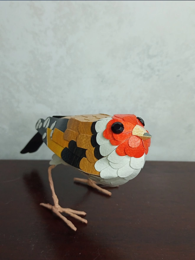 paper sculpture of a goldfinch bird