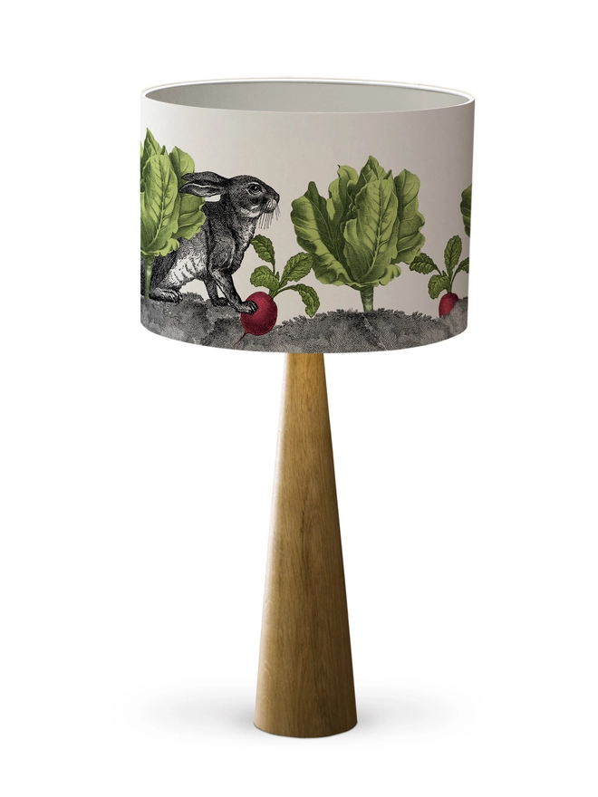 Mischievous rabbit lampshade handmade with vintage animal etchings, hiding among lettuces and radishes in a quirky country-style design. 