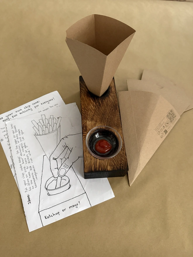 Chip cone and dip holder with guide to making your own cone .Come with 3 extra brown cardboard cones and small glass  dipping bowlwith spot of ketchup 